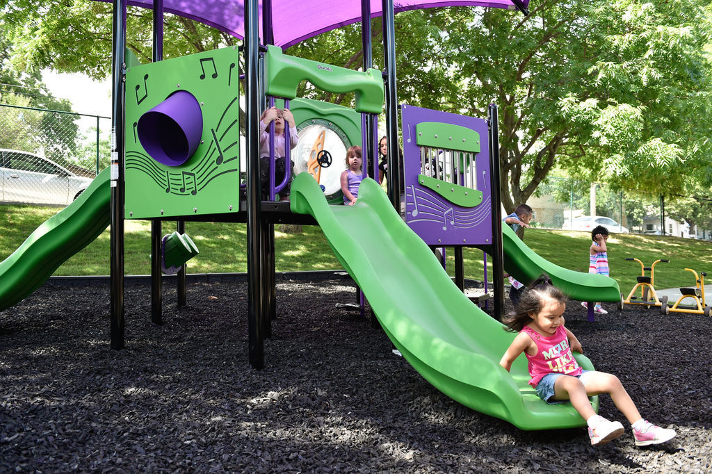 Children have fun on a newly built play area at Fred Moore Day Nursery School. Floyd Smith Concrete is the company that built the play area at Fred Moore Day Nursery School. The company is building it through a grant.